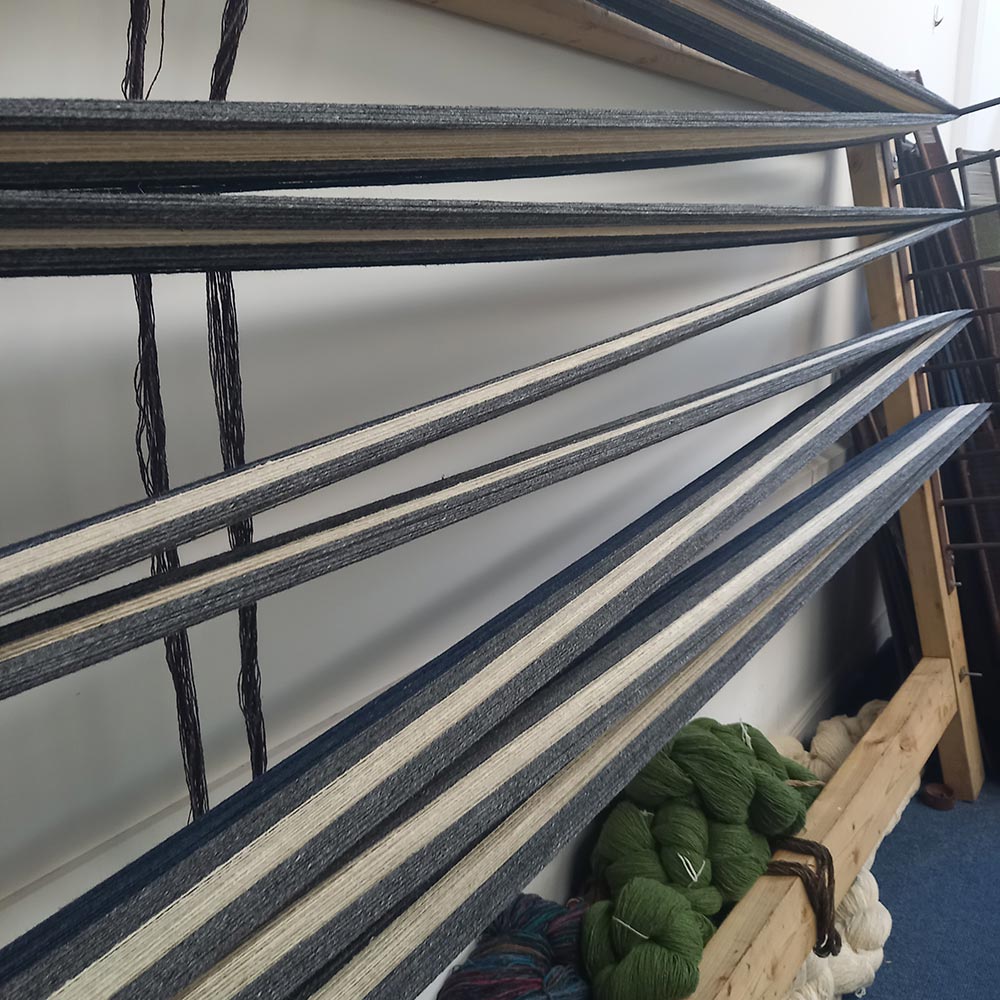 the metal bars of a warp beam.