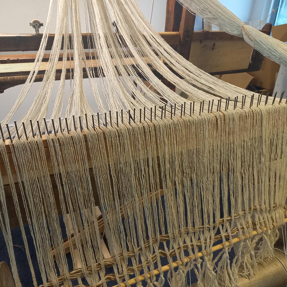 the metal bars of a warp beam.