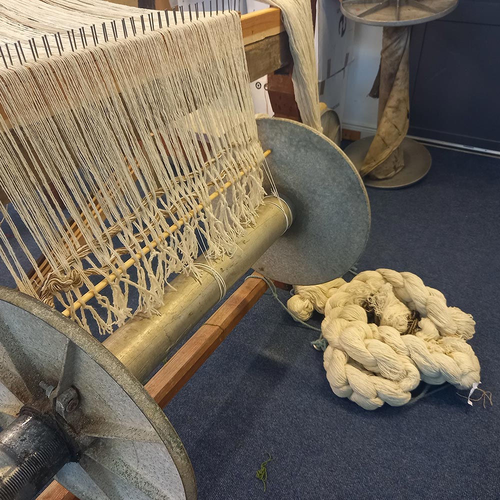 the metal bars of a warp beam.